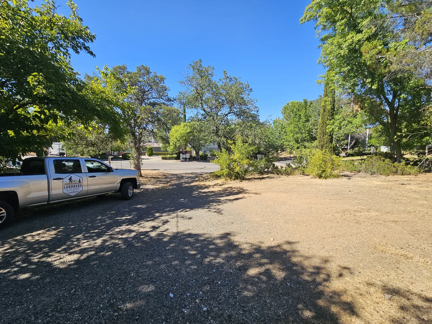 Wide view of a fully cleared lot with the work truck