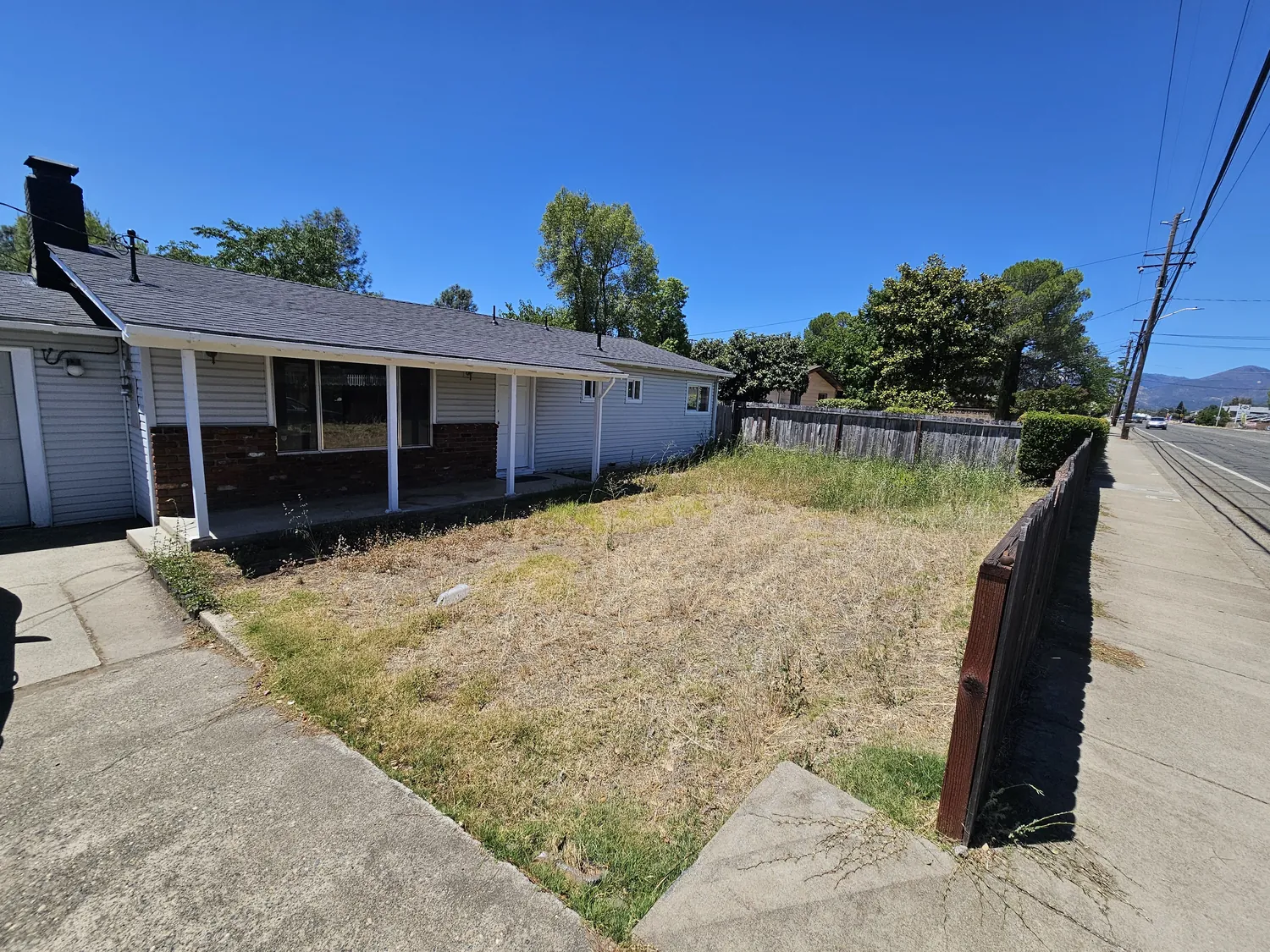 Yard cut short and cleaned around a home, the core of a defensible space job